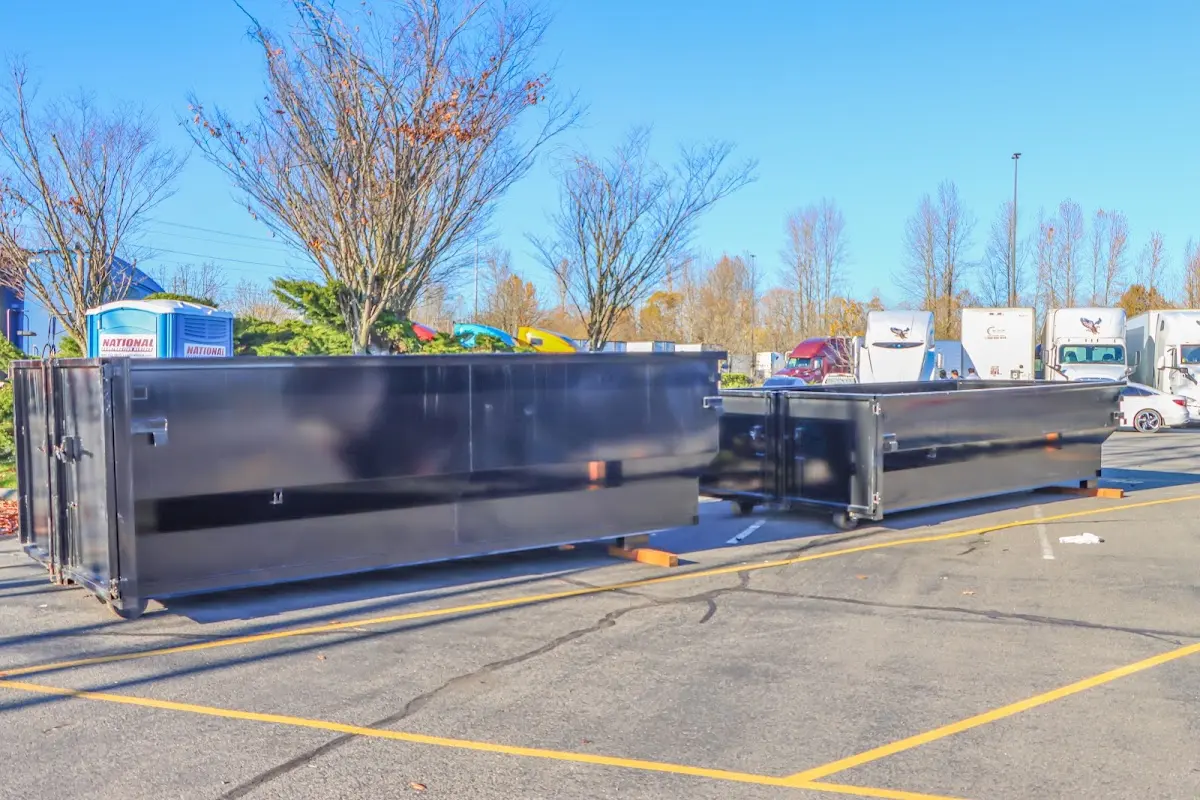 Professional dumpster rental service with roll-off container on residential driveway in South Bound Brook